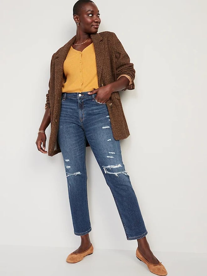 Black woman wearing a yellow cardigan, brown blazer, and ripped straight jeans in an article about o...