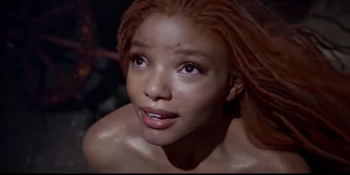 Halle Bailey as Ariel, a mermaid princess, and King Triton's youngest daughter	