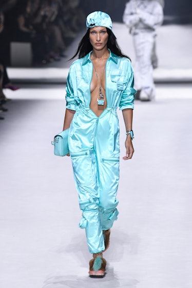 Bella Hadid walks the runway wearing a bright blue Baguette bag as a necklace and another one as a b...