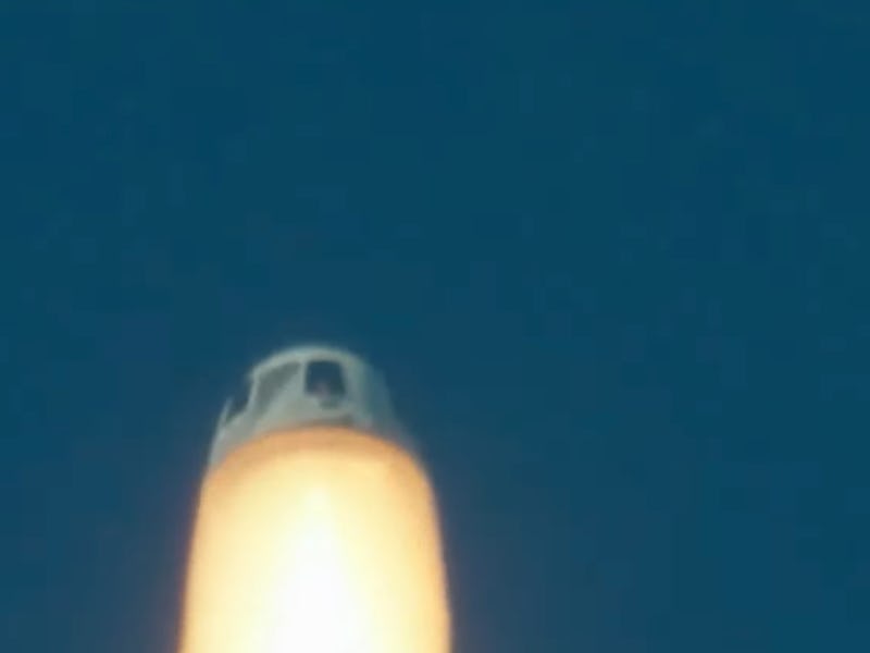 a capsule with large flames beneath it