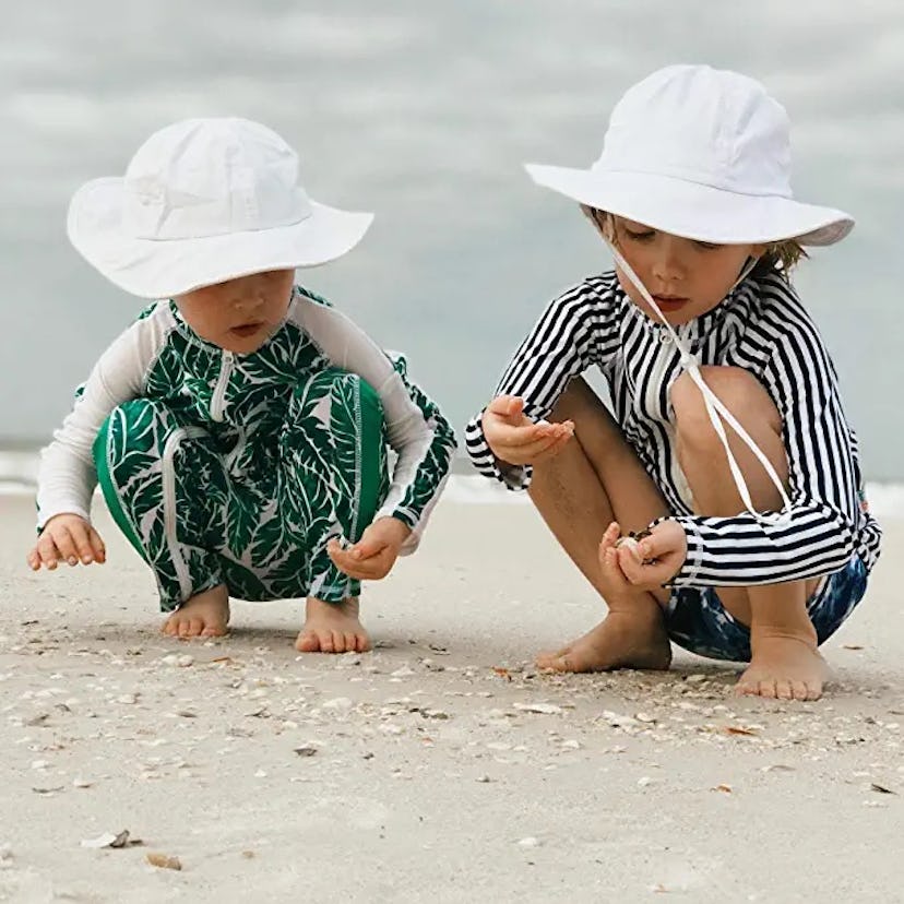 2 toddlers in white SwimZip Kid's Sun Hats