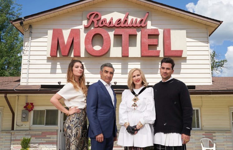 The Rose family from PopTV's 'Schitt's Creek' standing in front of the Rosebud Motel