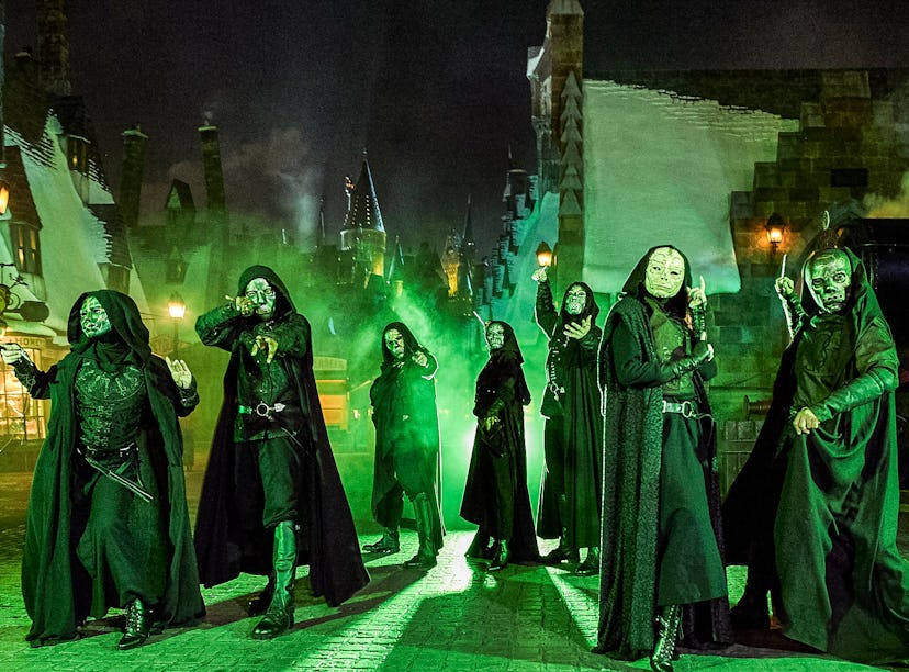 Halloween Horror Nights 2022 Death Eaters battle guests with wands in Hogsmeade from 'Harry Potter.'