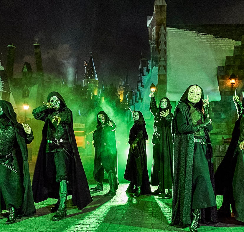 Halloween Horror Nights 2022 Death Eaters battle guests with wands in Hogsmeade from 'Harry Potter.'