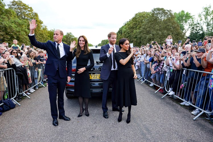 Kate Middleton, Prince William, Prince Harry, and Meghan Markle wave to the crowd after speaking to ...