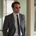 Charlie Cox wears a suit and red glasses as Matt Murdock in 'Daredevil' Season 1