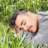 David LaChapelle resting his head on a bed of grass