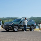 Young people on the beach with a VW SUV -  As An Essential Road Trip Tip From Chivalrous Drivers
