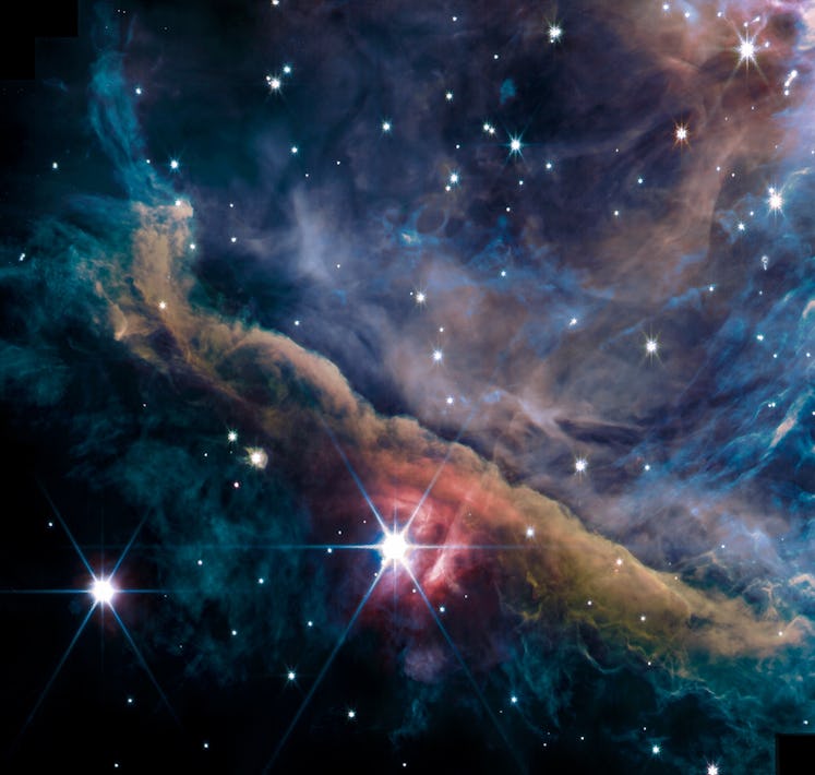 color image of a nebula and several bright stars in space