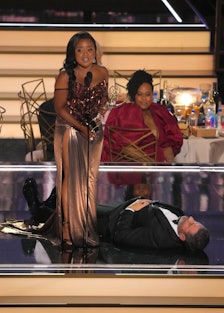 Quinta Brunson and a prostrate Jimmy Kimmel onstage of the 2022 Emmys