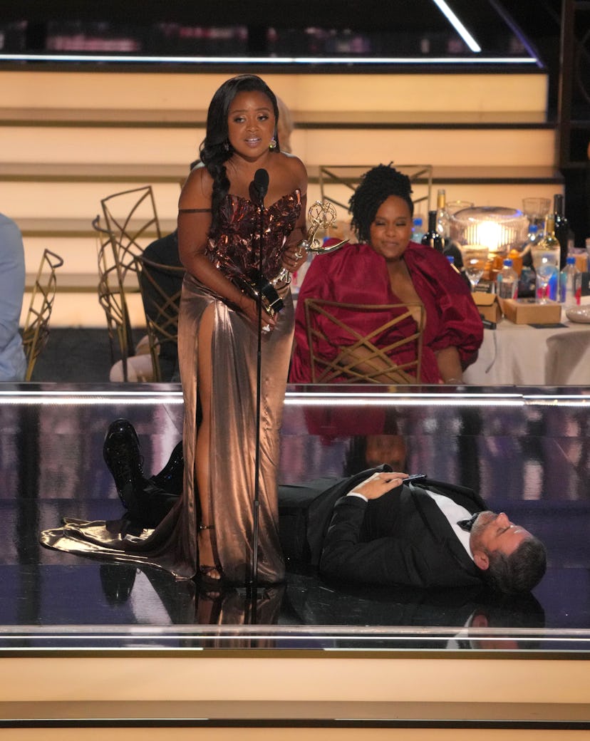 Quinta Brunson and a prostrate Jimmy Kimmel onstage of the 2022 Emmys