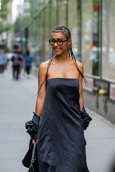 A guest wearing black off shoulder dress outside Brandon Maxwell on September 13, 2022 in New York C...