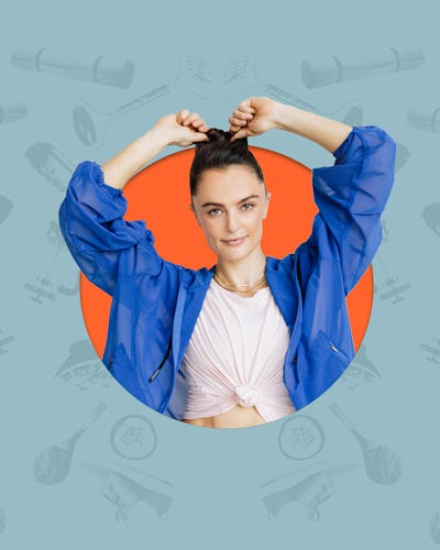 Megan Roup posing while touching her hair in a bun