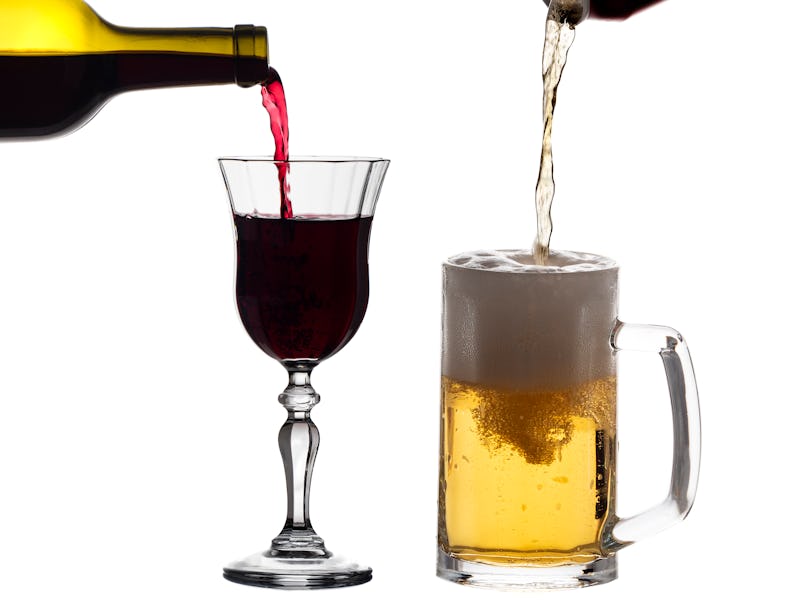 Wine and beer being poured into side by side glasses