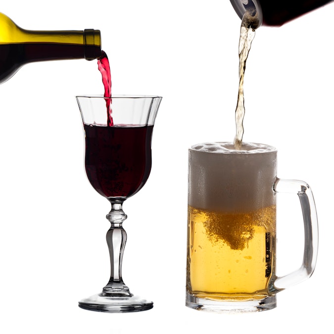 Wine and beer being poured into side by side glasses