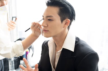 JENO getting his makeup done for the show