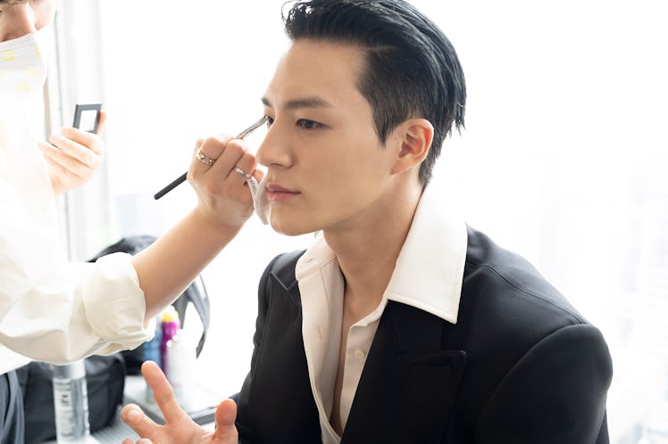 JENO getting his makeup done for the show