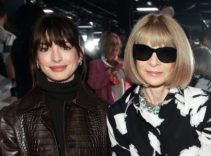 Anne Hathaway and Anna Wintour seated together at the Michael Kors Spring 2023 fashion show at New Y...
