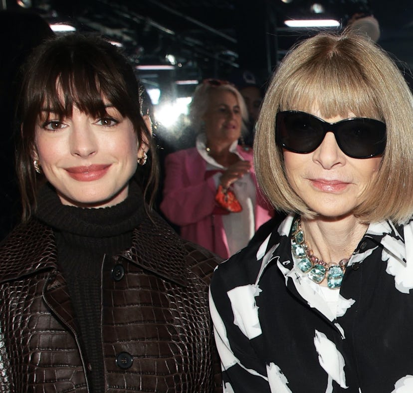 Anne Hathaway and Anna Wintour seated together at the Michael Kors Spring 2023 fashion show at New Y...