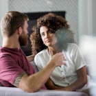 Man and woman sitting on couch having serious discussion