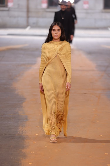 Xiye Bastida wearing a gold gown at the Gabriela Hearst spring 2023 NYFW show