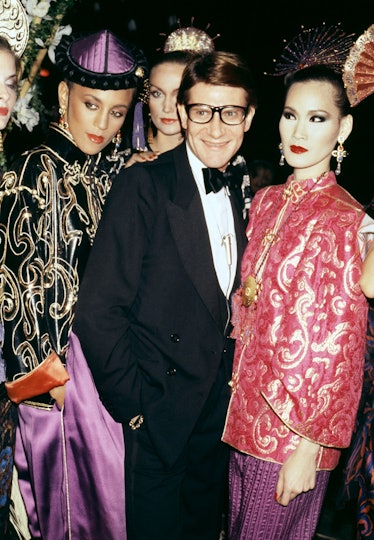 Yves Saint Laurent posing with models in a tux