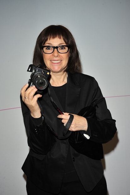 Roxanne Lowit holding up a camera