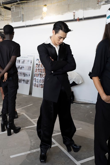 Jeno pensively waiting in the line of models before the show begins