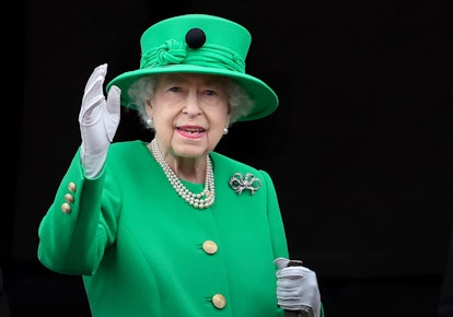 Queen Elizabeth II waving and wearing green