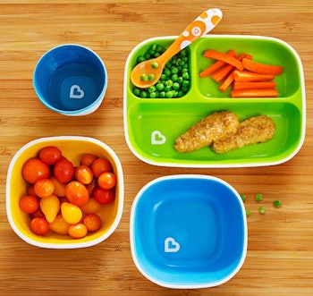 Blue and green toddler bowls with food in them