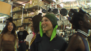 A person wearing a green hat with bunny ears