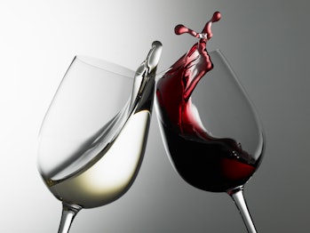 Clinking red and white wine glasses
