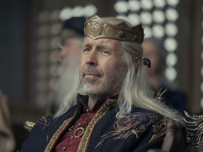 King Viserys watching a tournament from the show The House Of The Dragon.