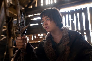 Theo (Tyroe Muhafidin) holds up a broken sword in The Rings of Power’s premiere
