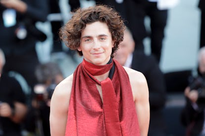 Timothée Chalamet wearing a red scarf and halter top