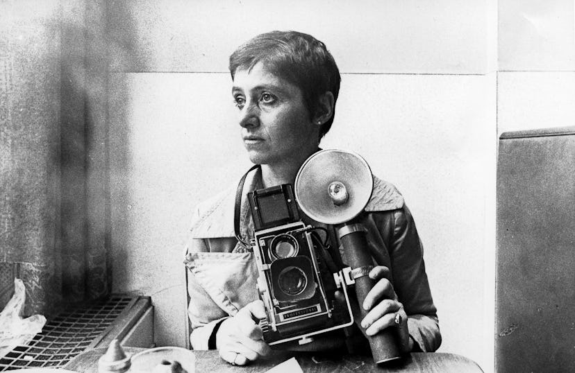 A young Diane Arbus holding up a camera in 1968