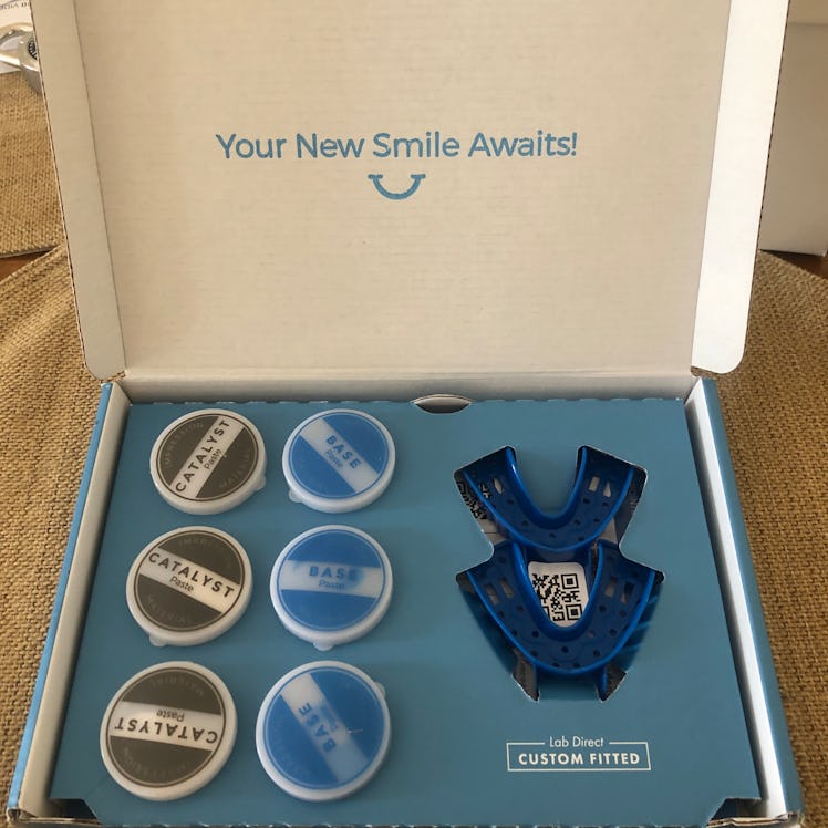 The inside of Smile Brilliant's kit, with 3 tubs each of base paste and catalyst paste, with trays t...