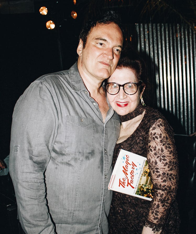 Quentin Tarantino and Lynn Hirschberg hugging for a photo at the 2022 Best Performances party