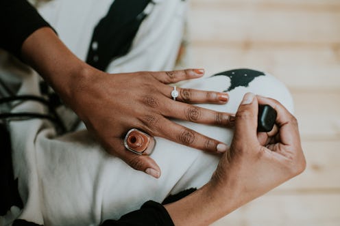 Woman painting her nails a milk chocolate brown color.