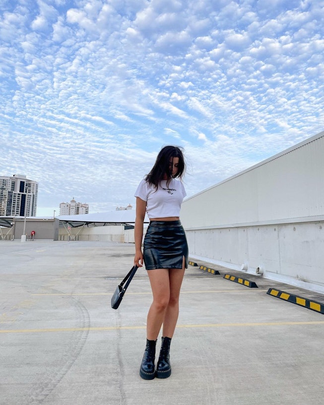 Influencer Erika Dwyer wearing Dr. Martens with a black leather mini skirt