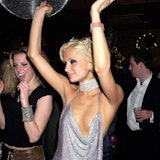 Paris Hilton dancing in silver dress.