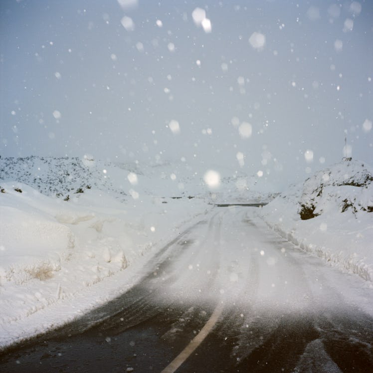 Snowflakes falling on a snowy road 