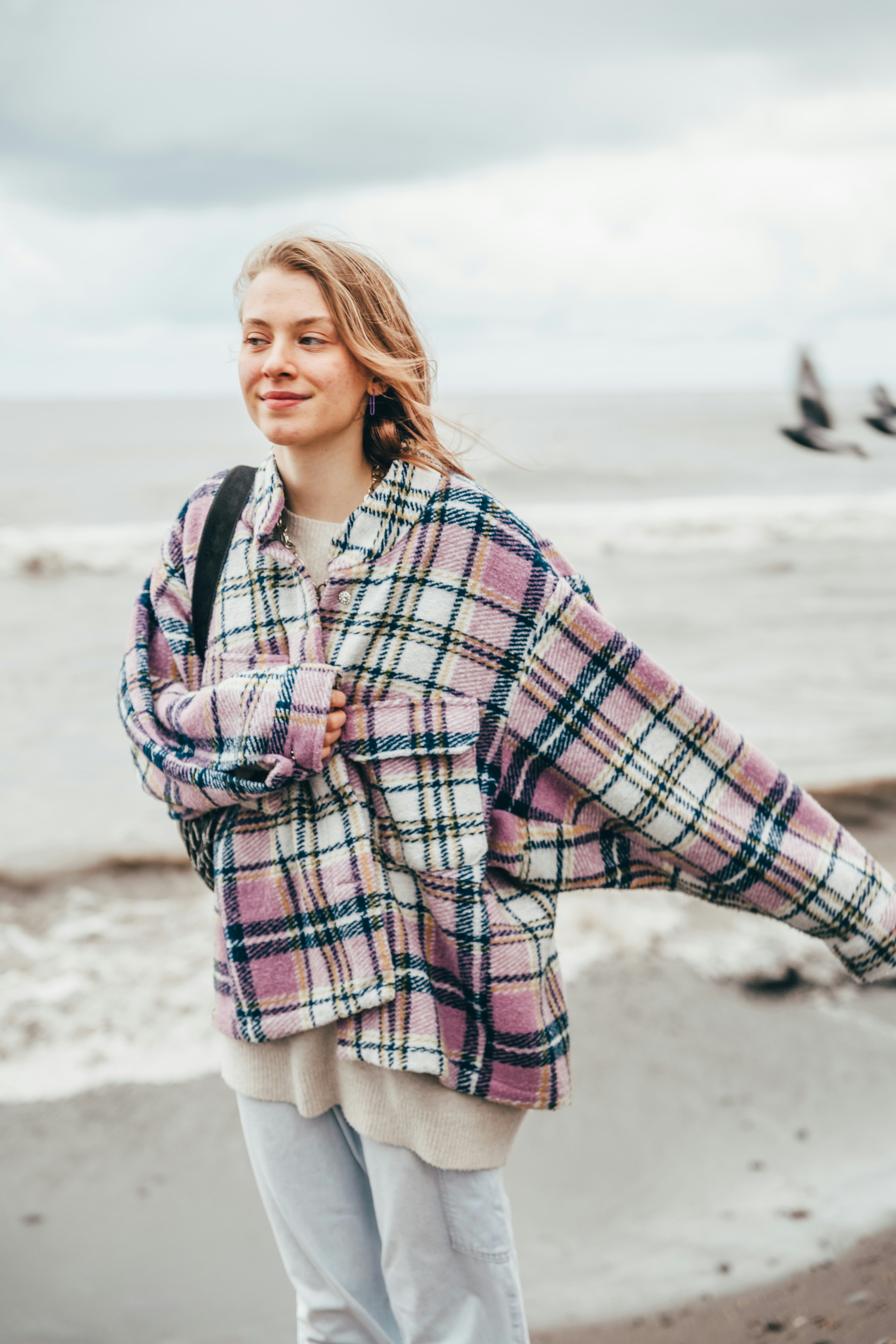 Young woman wearing an autumn shacket during the 2022 fall equinox, which will affect every zodiac s...