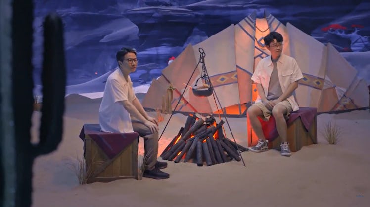 Genshin Impact developers sitting at tent with fire