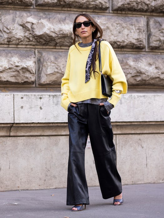 street style black pants yellow sweater