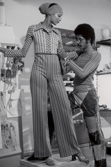 Stephen Burrows fitting clothes to a model