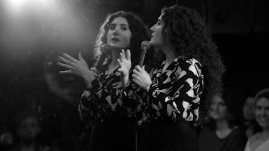 Kate Berlant looking at herself in the mirror during her comedy special.