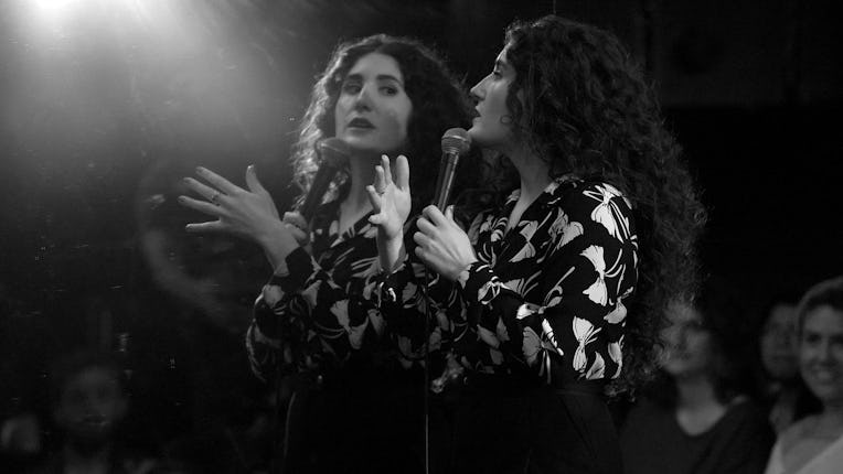 Kate Berlant looking at herself in the mirror during her comedy special.