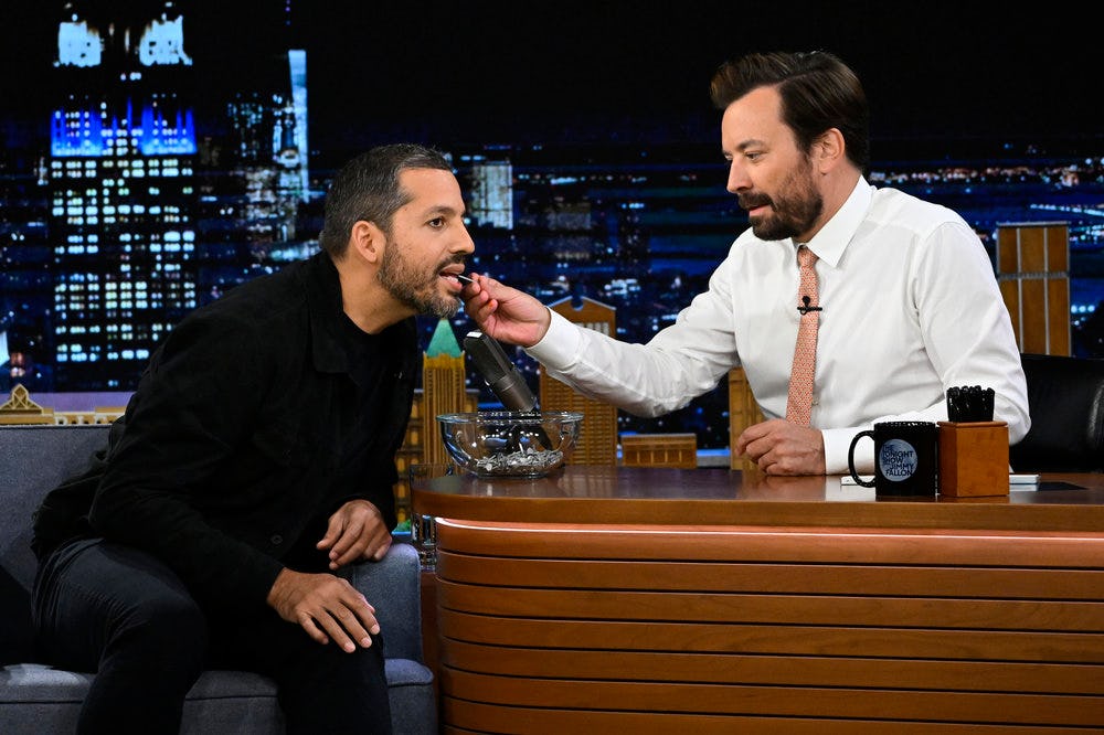 Jimmy Fallon feeding something to David Blaine on the Tonight Show.