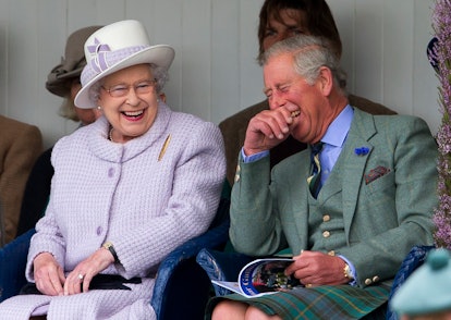 Queen Elizabeth II and Prince Charles, Prince of Wales laugh whilst watching the children's sack rac...